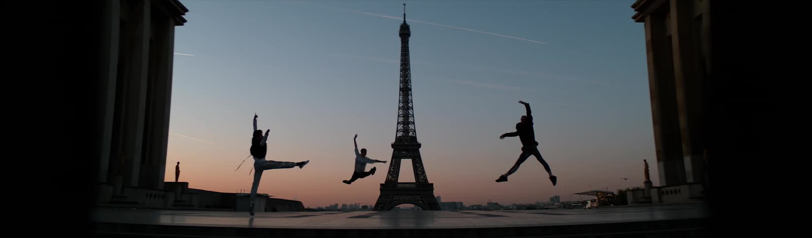 A group of people dancing at the eifel tower