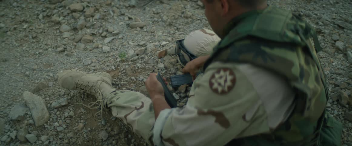 A soldier loads bullets into a magazine