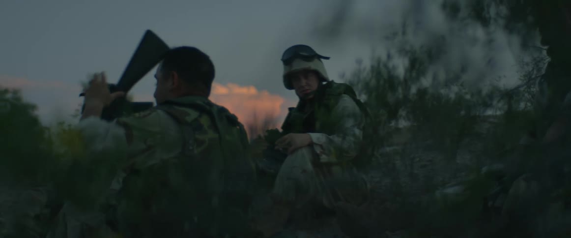 A soldier is checking his rifle