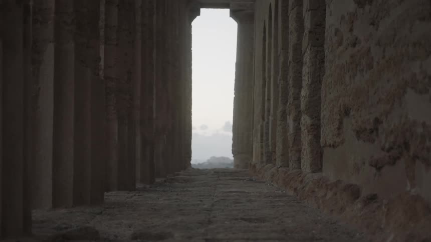 A weathered stone building on a foggy day