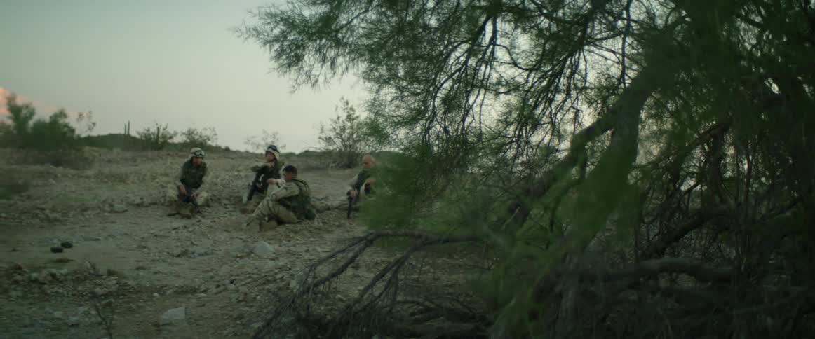A group of soldiers sitting outdoors