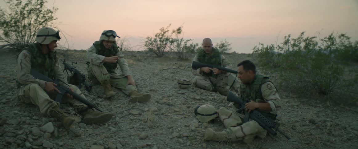 A group of soldiers sitting outside