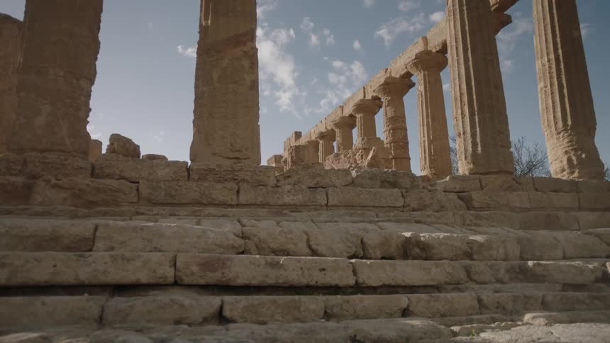 Stone steps lead to pillars and ruins