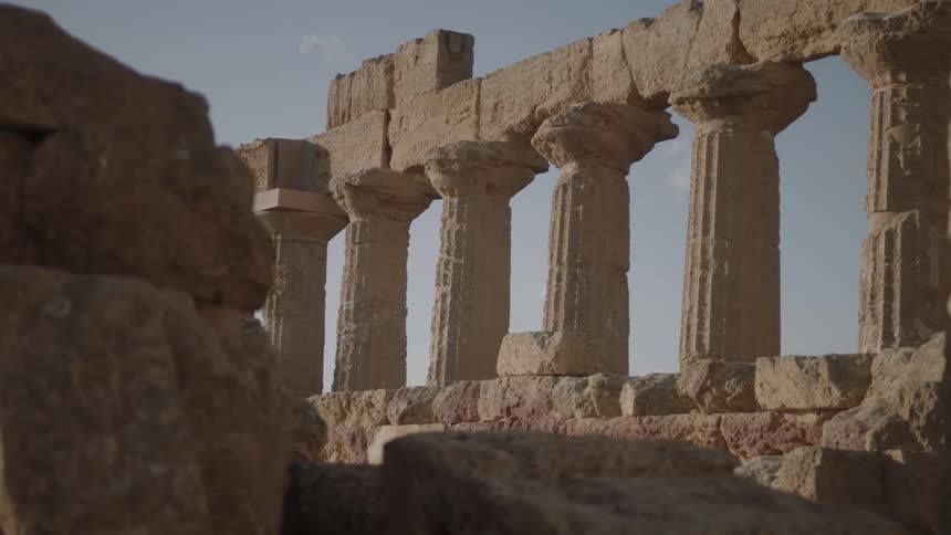 Stone pillars and ruins outside on a sunny day