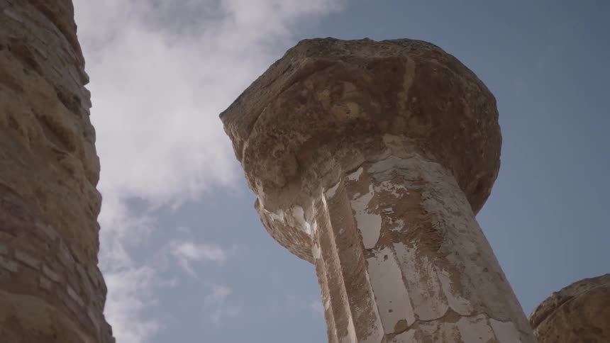 Old stone pillars tower overhead