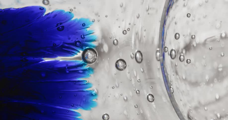 Blue dye spreads in a viscous clear liquid