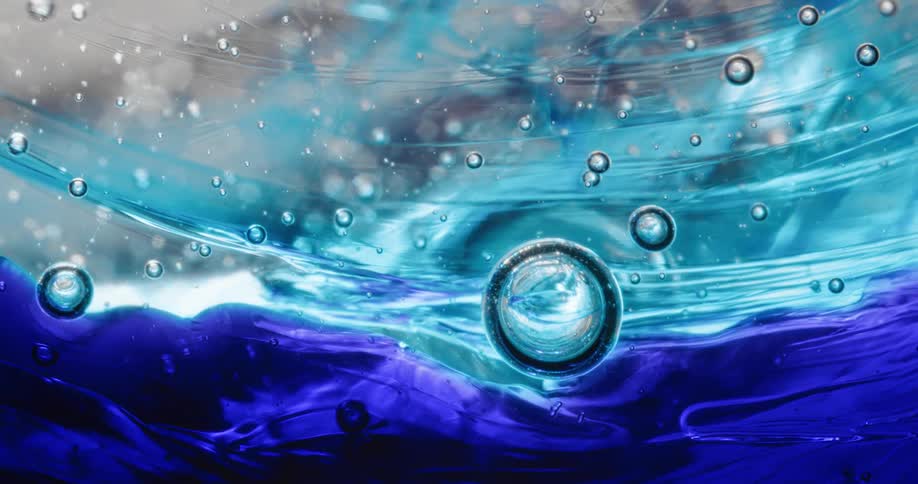 Liquid with two tones of blue with bubbles in it moves