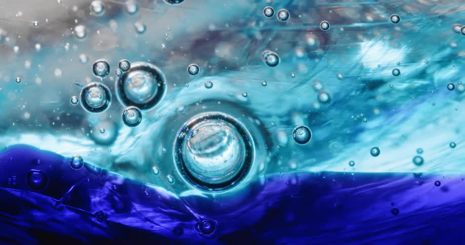 Bubble spheres float across a rippling blue organic environment