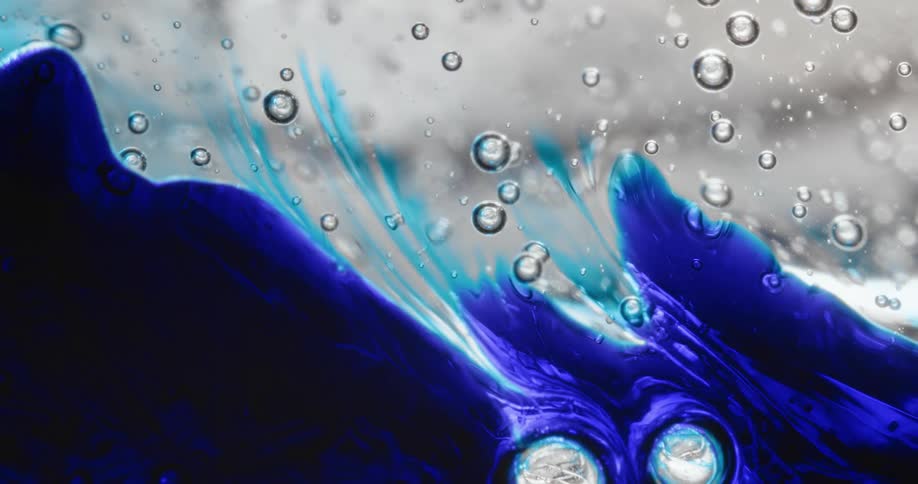 A blue dye tries to spread in a thick clear liquid