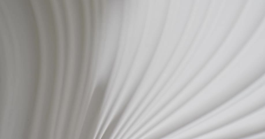 Light shines on a white textured substance and creates shadows in the grooves