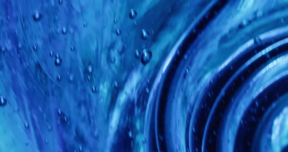 Air bubbles trapped on the ripples of a thick gel tinted with deep blue ink