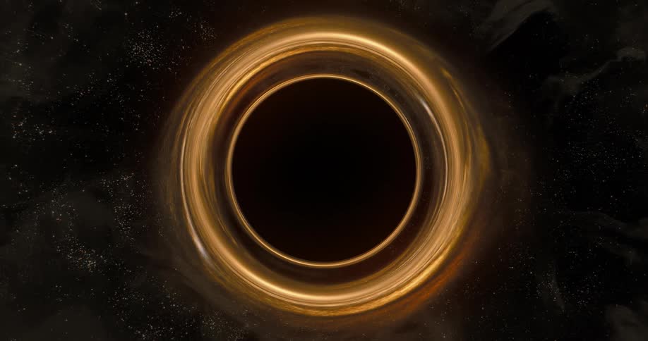 Gold ring spins in center of dark mass sprinkled through with shiny particles