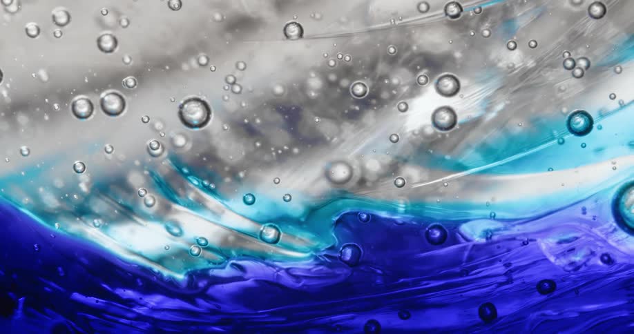 Flowing blue and clear liquid with bubbles