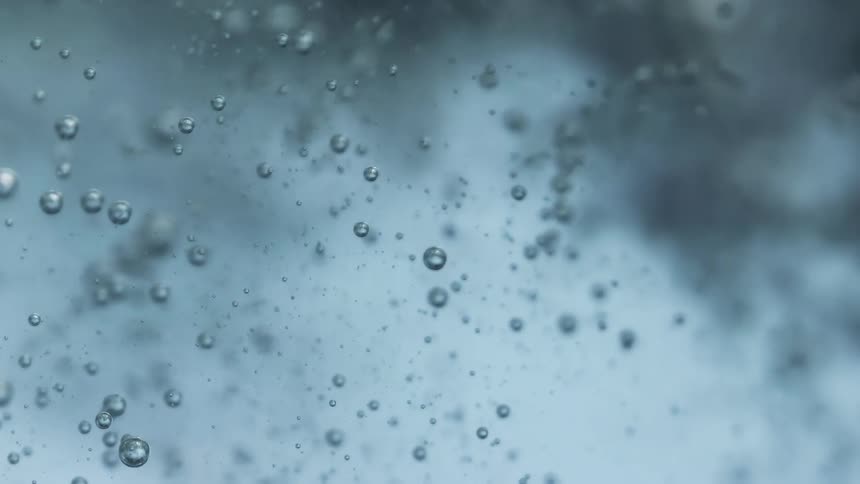 Close up of air bubbles floating up and down in water