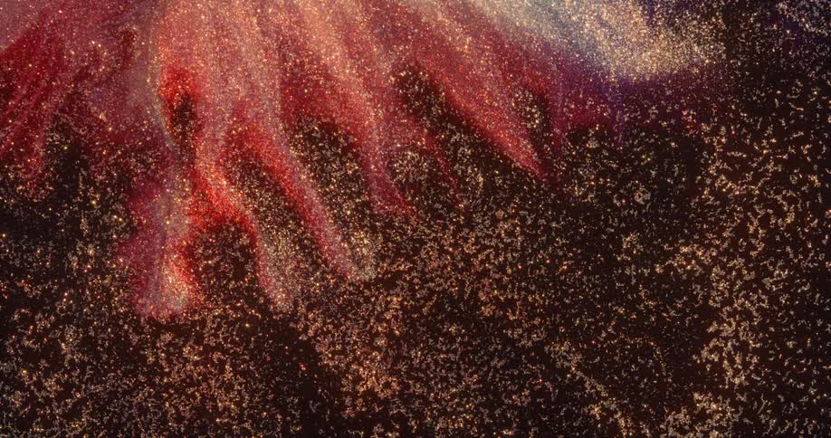 A sparkling organic galaxy moves in an environment with red blending in from above