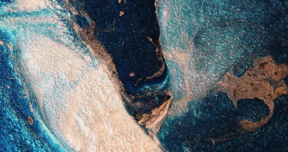A turquoise substance with gold blending into it is overcome by the white area absorbing it from underneath