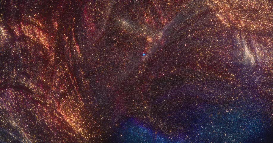 Coppery mixture expands and blends with blue mixture as particles glint and sparkle