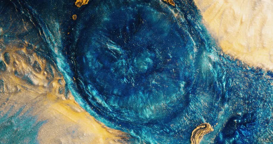 Bright blue paint expands into gold tinted paint