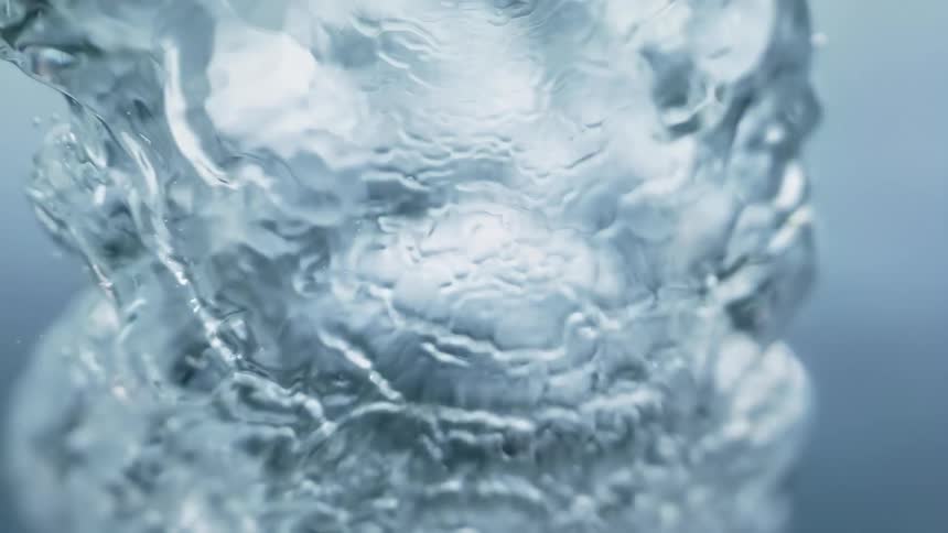 Poured water forms ripples in a tub already filled with water