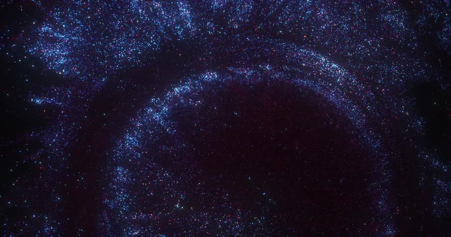 Blue glitter is twinkling and sparkling in the darkness as an echo sends a rippling ring through the universe