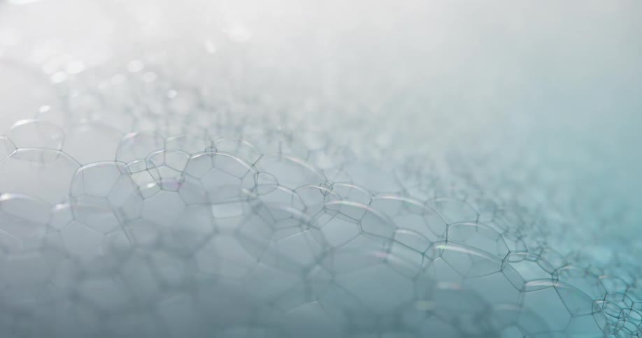 Cloudy foaming bubbles bob on surface of liquid