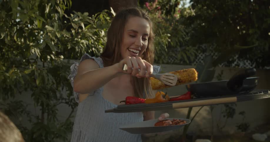 A woman fills her plate with food