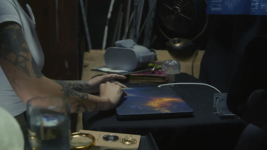 A woman sits and opens her laptop