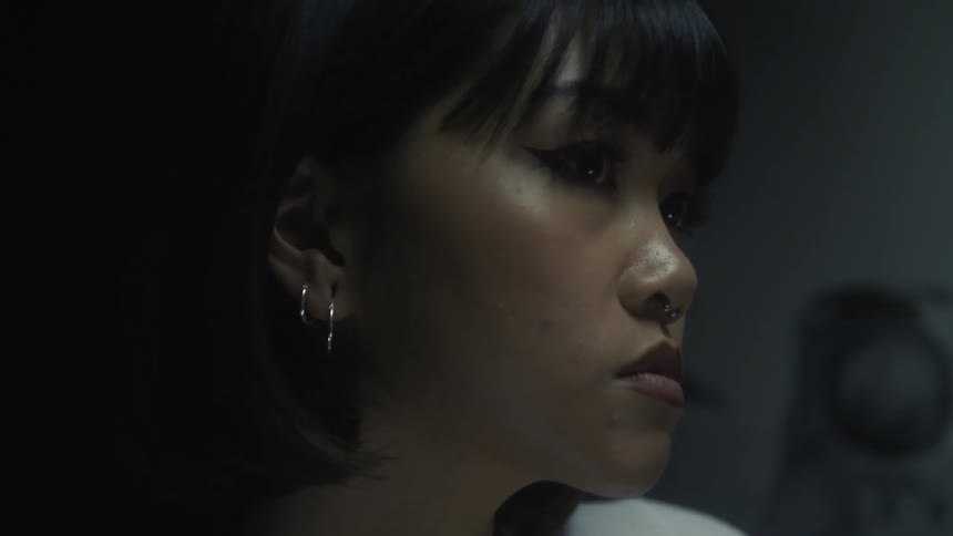 A woman turns her head and blinks