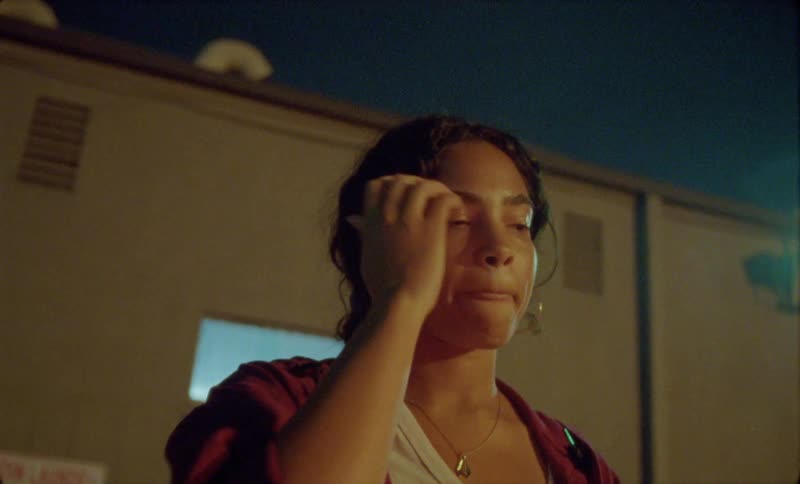 A young man and woman are hanging out with each other at night time