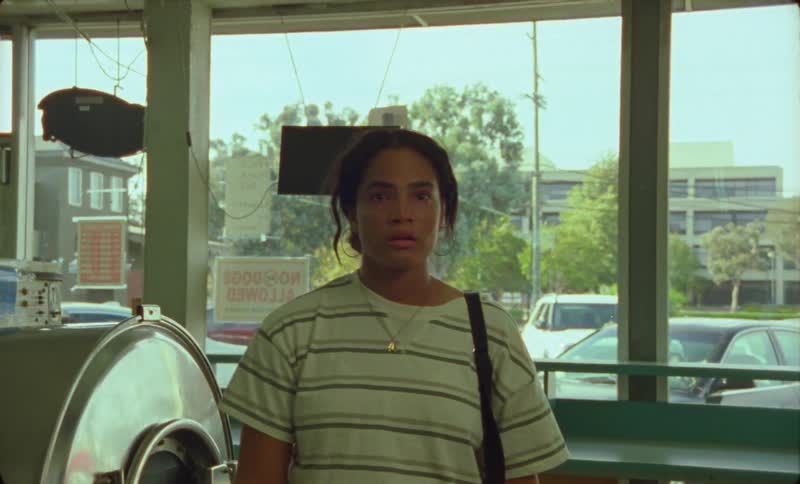 A woman walks into a laundromat and stops staring in surprise