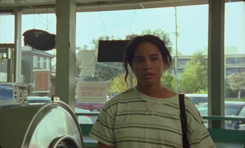 A woman walks into a laundromat and stops looking frightened and taking deep breaths