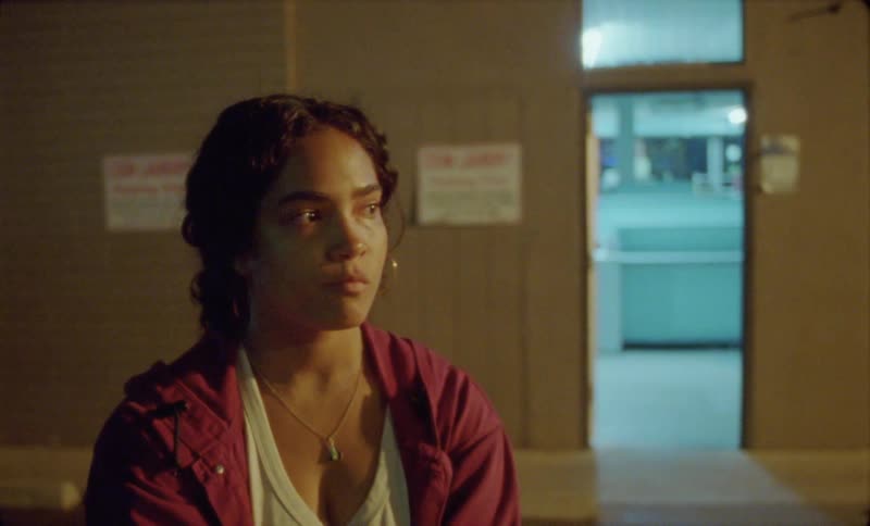 A young hispanic woman indoors and walking away