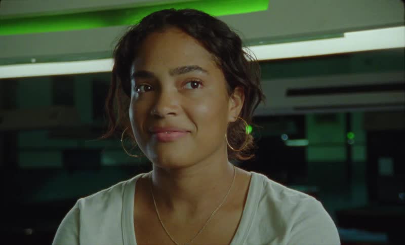 Young latina woman listening at someone talking out screen