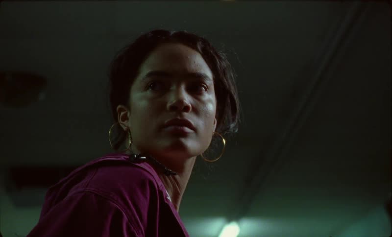 A woman sitting in a commercial space becomes alarmed when the light goes off