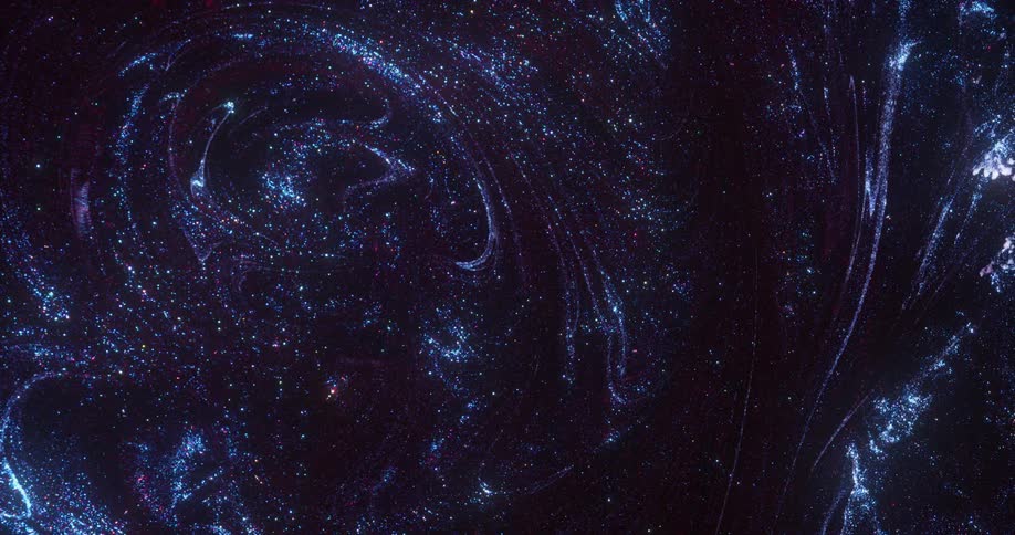 Bright sparkling shiny specks of blue glitter floating over a black bacground