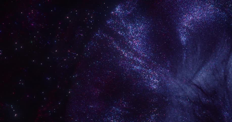 Bright blue glittering specks floating on a dark background flowing in slow waves