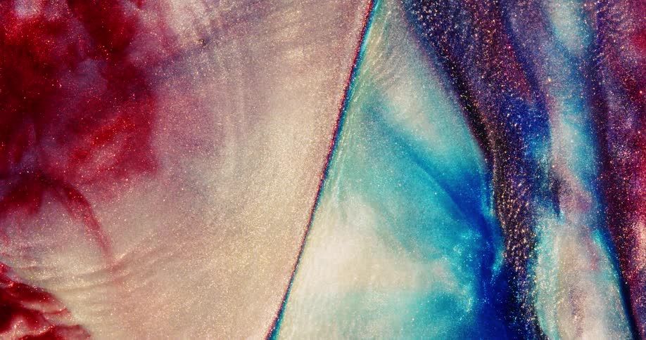 Waves of colorful liquid glitter roll into each other
