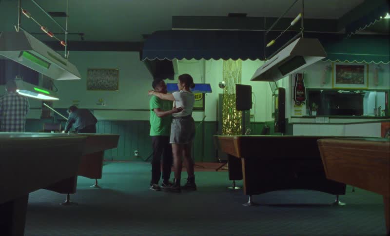 Two people are dancing in the pool hall