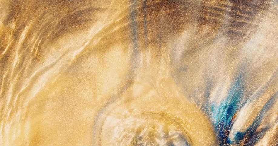 Ripples of gold glitter move forward with a textured substance moving with turquoise blending in from behind