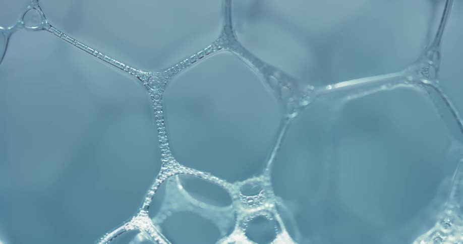 A clear bubble substance reflects light as it moves and parts connect and disconnect from their sides