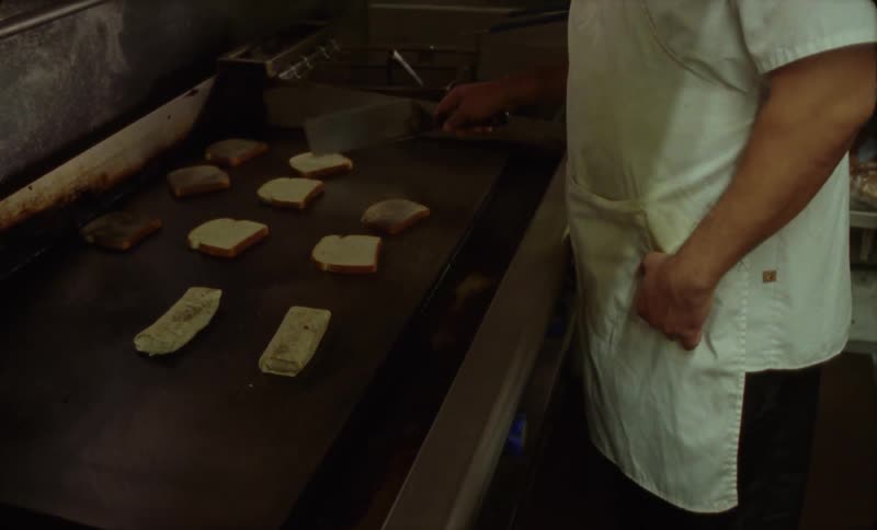 A white man is cooking and preparing food at the restaurant