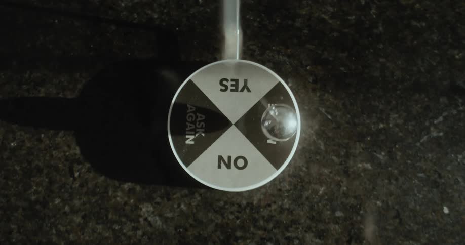 Close up of the moving pendulum on a magnetic decision maker toy
