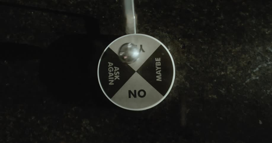 Close up of the moving pendulum on a magnetic decision maker toy