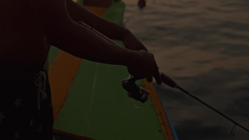 A child fishing off a dock