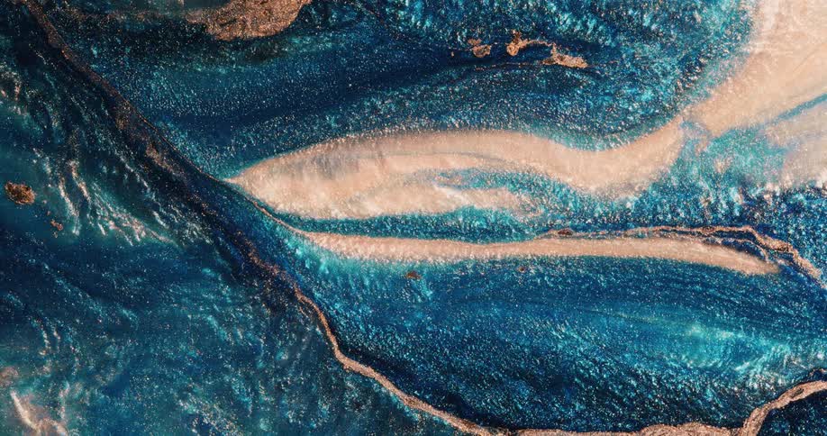 Texture in a turquoise organic environment is moving and rippling as golden bands of glitter blend into many shades of yellow