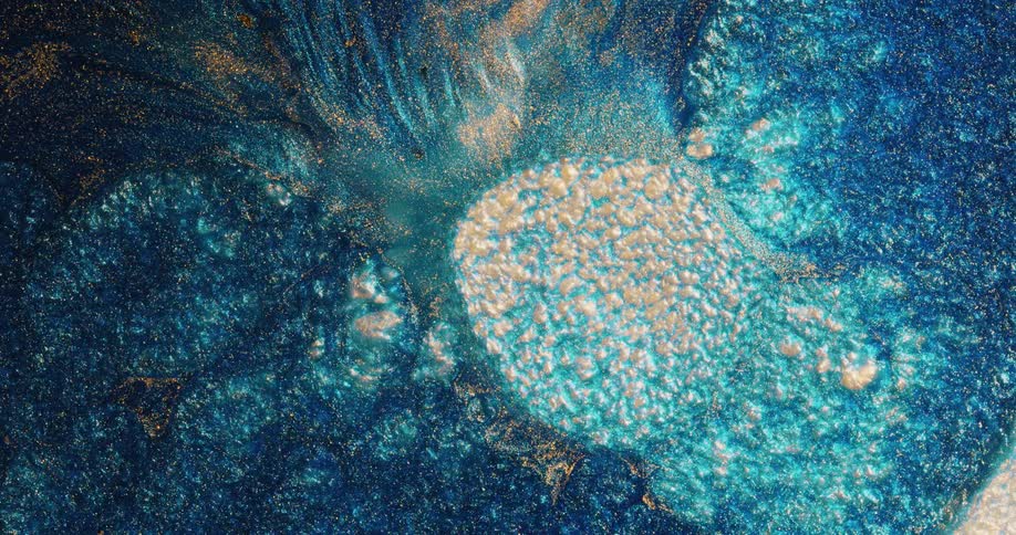 A rounded textured turquoise and yellow area shrinks as it is absorbed by a darker glittery substance