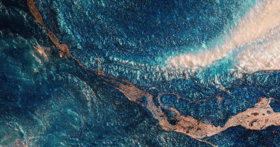 Multi hued mixture predominately colored blue white and gold ripples and flows