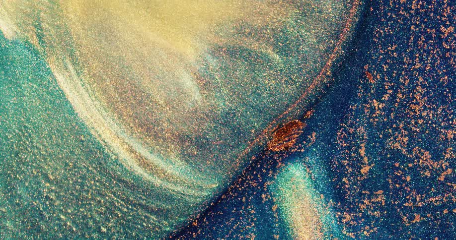 A colorful mass floating on the surface is pushed by waves and flowing color