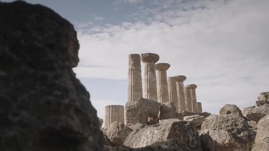 Pillars stand in the distance on a cloudy day