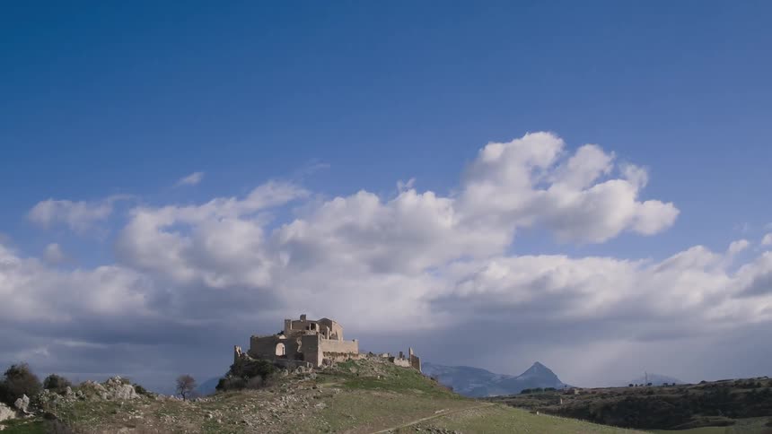 A large hillside castle on a cloudy day